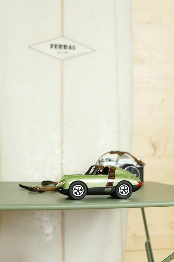 Decorative retro small Convertible olive green  chrome helmet driver playforever luft hopper side view  on a shelf 