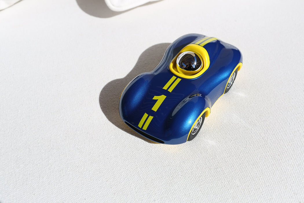Summery and shiny outdoor top view of blue and yellow line chrome helmets driver Playforever Le Mans Boy 